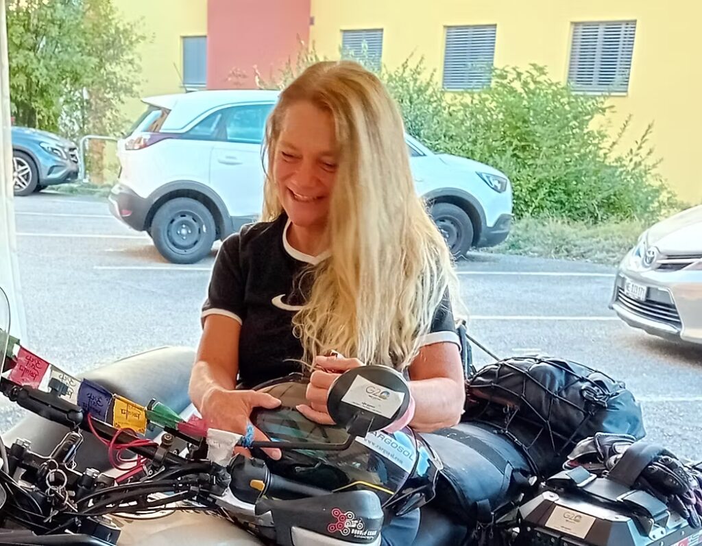 Alicia beside her bicycle loaded with luggage